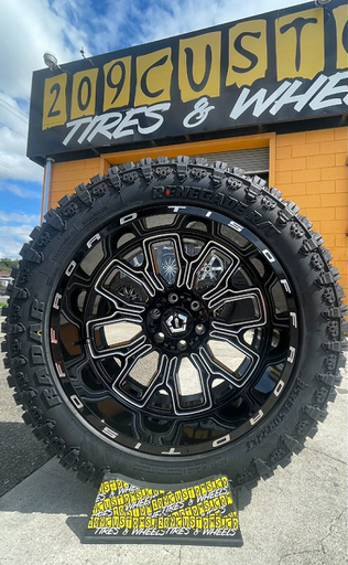 TIS 560BM 22X12 6X139.7 BLACK AND MILLED WITH MUD TIRES